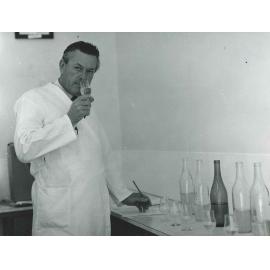 Bob Baker Evaluates Wine, c1980